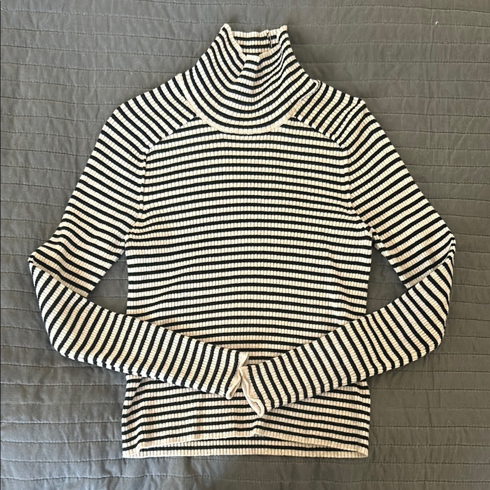 This sweater hugs the body, really comfortable under hoodies or blouses.